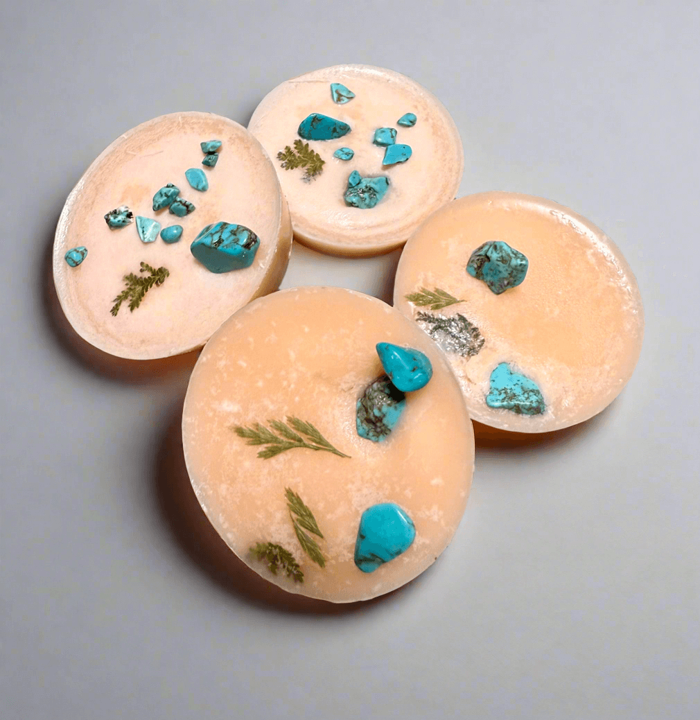 Handmade blood orange scented wax tarts infused with turquoise crystal chips and herbs, perfect for creativity and self-care.