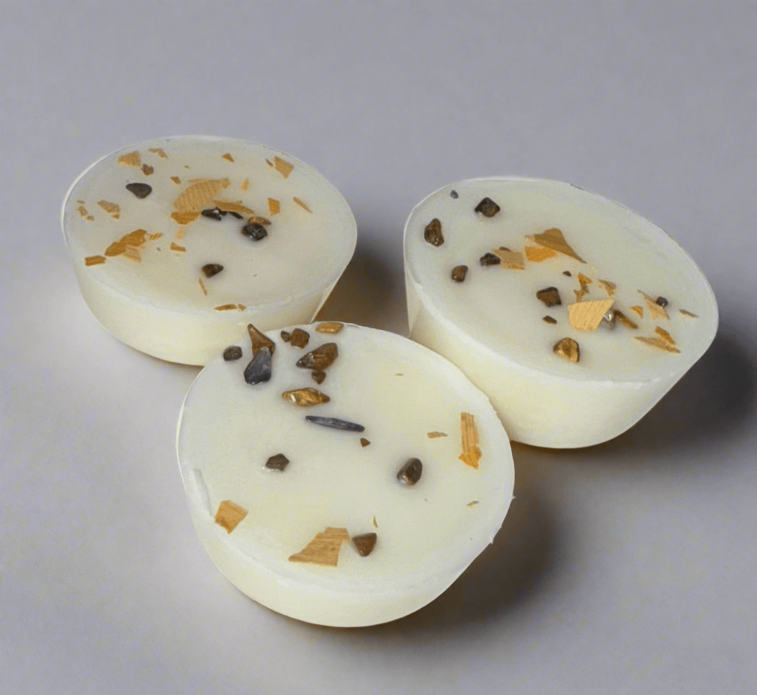 Handmade Sea Salt & Cocoa Bean wax melts with herbal toppings, infused with crystals for relaxation and grounding.