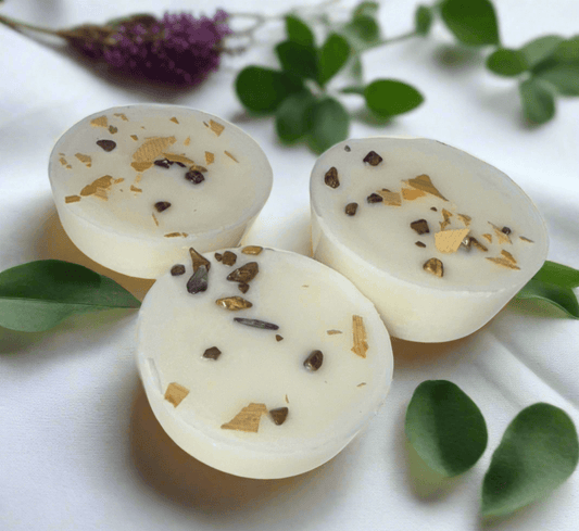 Handmade sea salt and cocoa bean infused wax melts with herbs and crystals, perfect for relaxation.