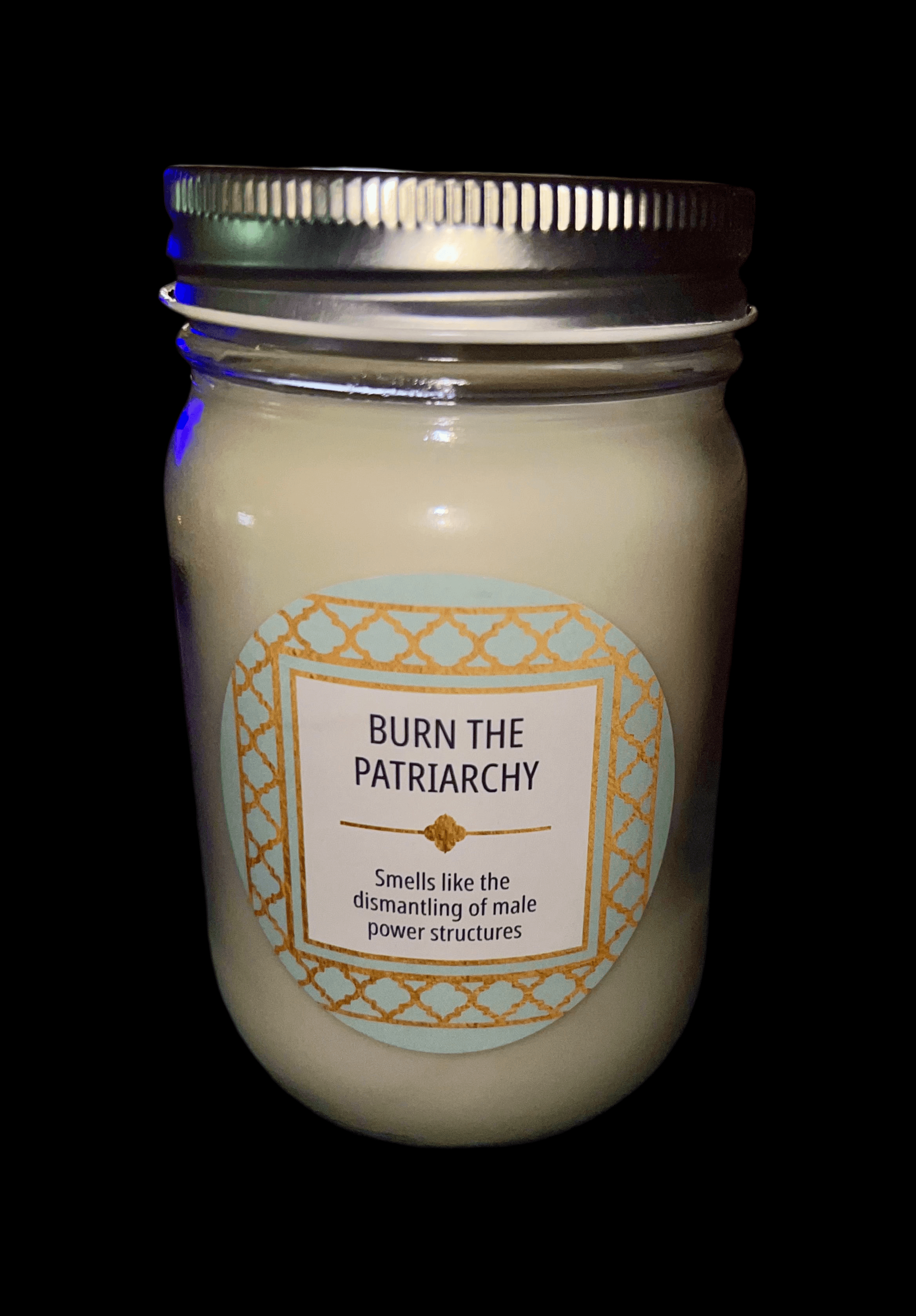 14 oz Burn the Patriarchy scented candle in a glass jar with a decorative label.
